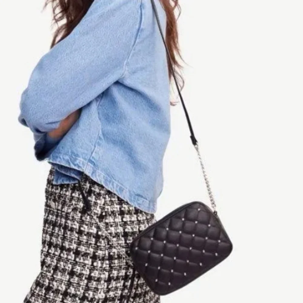 Rebecca Minkoff• Mini quilted studded black crossbody bag. 7.25” x 2.25” x 5.25”